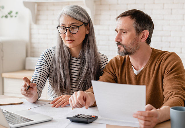 middle-aged couple reviewing their finances